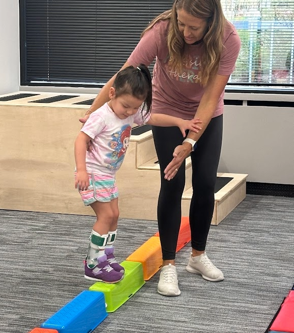 Owner Terra helping a child learn to climb a slope